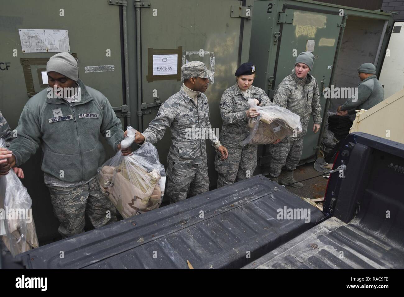 108th Security Forces Members pass equipment bucket line style out of a storage unit at the 108th Wing, Joint Base McGuire-Dix-Lakehurst, N.J., Jan. 17, 2017. The 108 Airmen move the equipment for counting, inspection, and distribution, in preparation of the 58th presidential inauguration later this week. Stock Photo