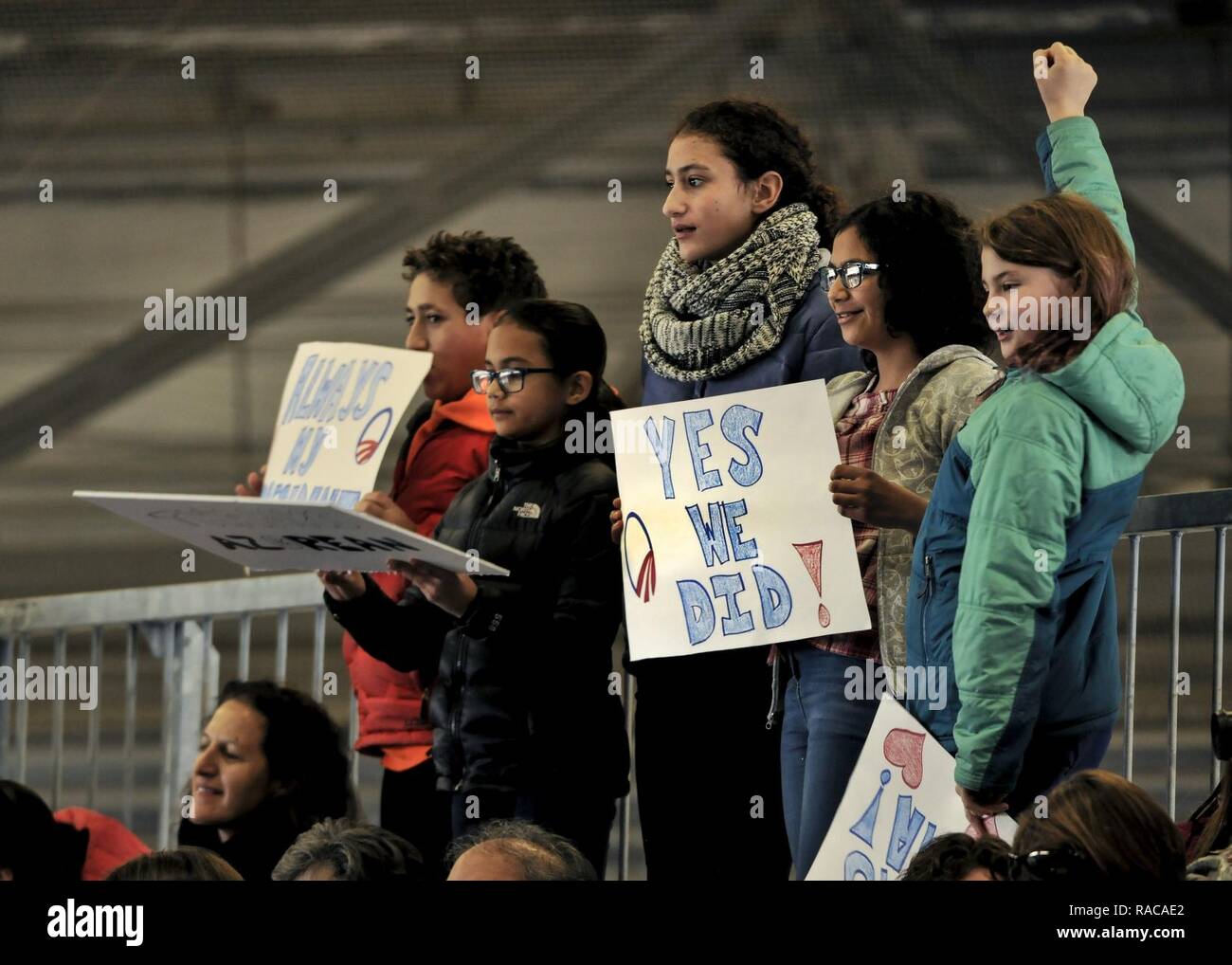 Children hold signs in support of former President Barack Obama during his farewell speech at Joint Base Andrews, Md. Jan. 20, 2017. After his speech Obama and his wife Michelle took time to shake hands and exchange hugs with members of the crowd before boarding a plane to depart. Stock Photo