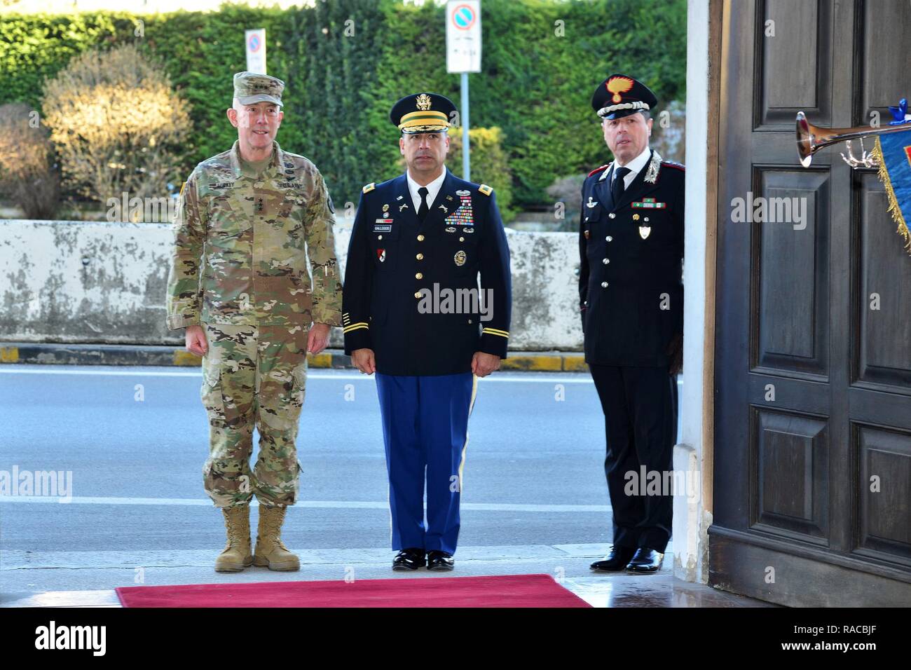 Lt. Gen. Charles D. Luckey (left), Commanding General U.S. Army Reserve Command, U.S. Army Col. Darius S. Gallegos (center), CoESPU deputy director and and Col. Roberto Campana (right), chief of staff CoESPU, render salutes during the playing anthems during visit at Center of Excellence for Stability Police Units (CoESPU) Vicenza, Italy, January 20, 2017. Stock Photo