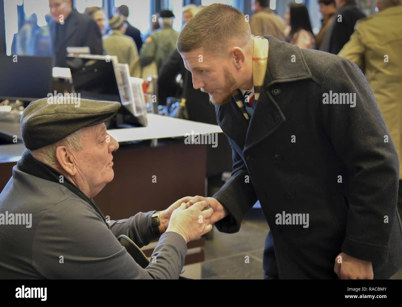 Former U.S. Army Spc. Kenneth Stumpf, Medal of Honor recipient and retired U.S. Marine Corps Cpl. William Kyle Carpenter, Medal of Honor recipient, exchange coins during a traditional Inaugural Day Medal of Honor breakfast held at the Reserve Officers Association headquarters in Washington D.C., January 20, 2017. Stock Photo