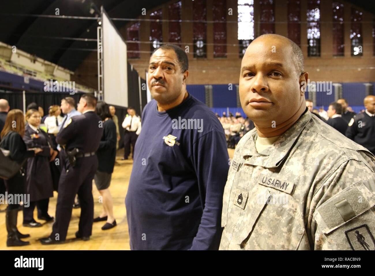 U.S. Army Sgt. 1st Class Earlito Frazer-Sinclair,  information branch chief  and Master Sgt. Rodney Spencer, facility program and planning manager, District of Columbia National Guard watch the swearing-in of police officers in Washington, D.C. on Jan. 19, 2017. The Metropolitan Police Department held a swearing-in of police officers from several states at the DC Armory in support of the 58th Presidential Inauguration, Jan.20. (National Guard Stock Photo