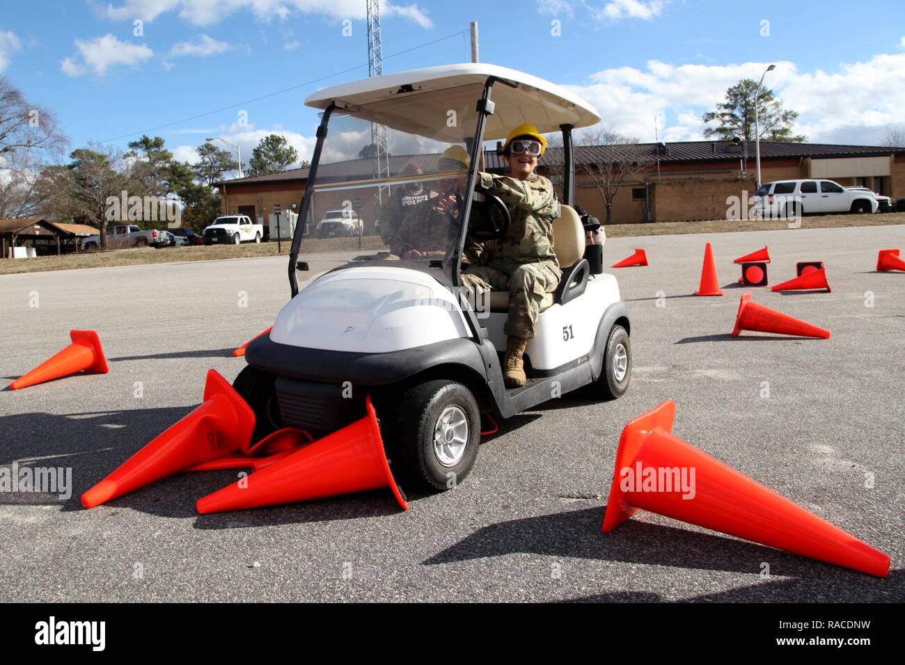 A Soldier, wearing vision distorting “drunk goggles” meant to simulate a blood alcohol content between .08 and .15, grinds a golf cart to a halt, unable to proceed further down a simple cone course, Jan. 12, 2017. The Fort Bragg Provost Marshall Office Traffic Division assisted 7th Military Information Support Battalion, 4th Military Information Support Group, to conduct an alcohol awareness safety class to raise awareness of alcohol’s rapid effects and to deter drunken driving. Stock Photo
