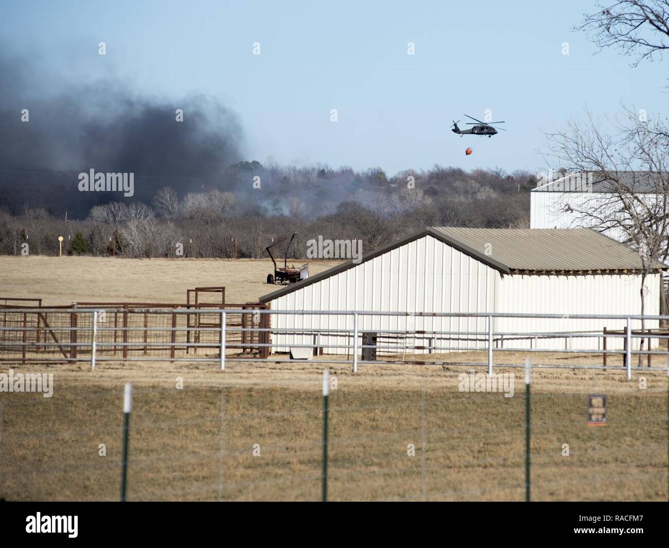 Oklahoma Army Guardsmen were called out to support local firefighters in Edmond on January 24. Eight Soldiers on two UH-60 Blackhawk helicopters equipped with Bambi Buckets flew nearly three hours and dropped 30 buckets, releasing around 19,800 gallons of water on a wild fire that engulfed houses in the area. Oklahoma’s Office of Emergency Management requested the helicopters on standby due to the high threat of wildfires. One helicopter assigned to Detachment 1, Company C, 1st Battalion, 169th Aviation Regiment in Lexington, Oklahoma, and one helicopter assigned to Company C, 1st Battalion, 2 Stock Photo