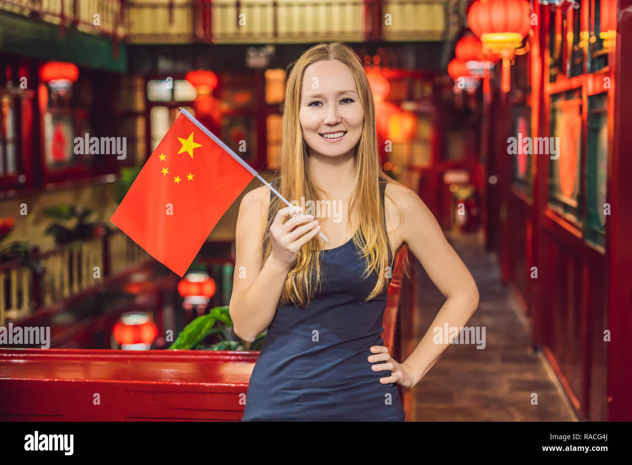 Enjoying vacation in China. Young woman with a Chinese flag on a Chinese background. Travel to China concept. Visa free transit 72 hours, 144 hours in China BANNER, LONG FORMAT Stock Photo