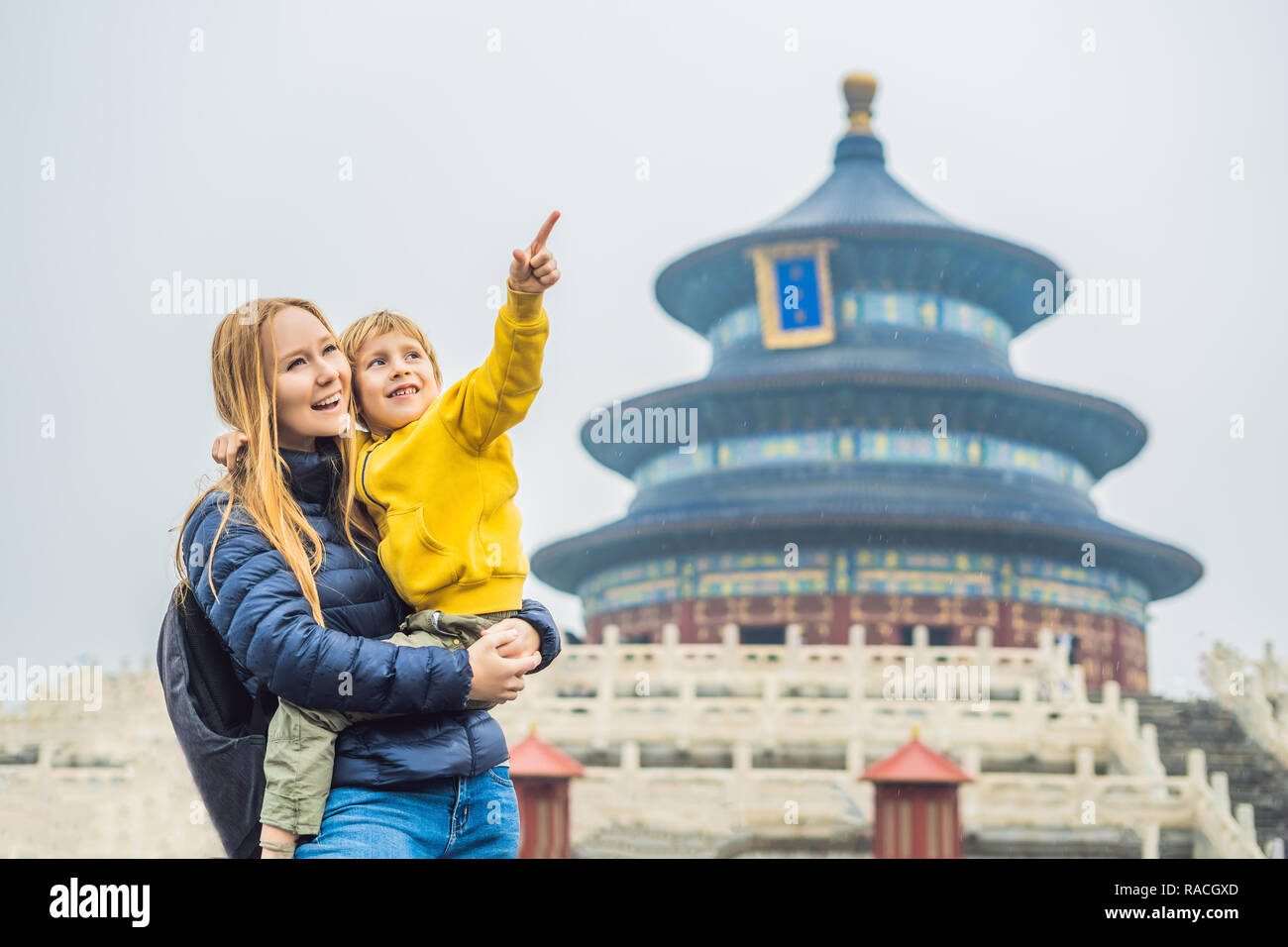 Mom and son travelers in the Temple of Heaven in Beijing. One of the main attractions of Beijing. Traveling with family and kids in China concept Stock Photo