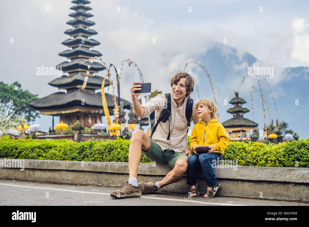 Dad And Son In The Background Of Pura Ulun Danu Bratan Bali