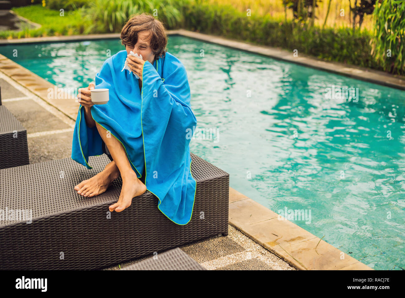 Sick man traveler. The man caught a cold on vacation, sits sad at the