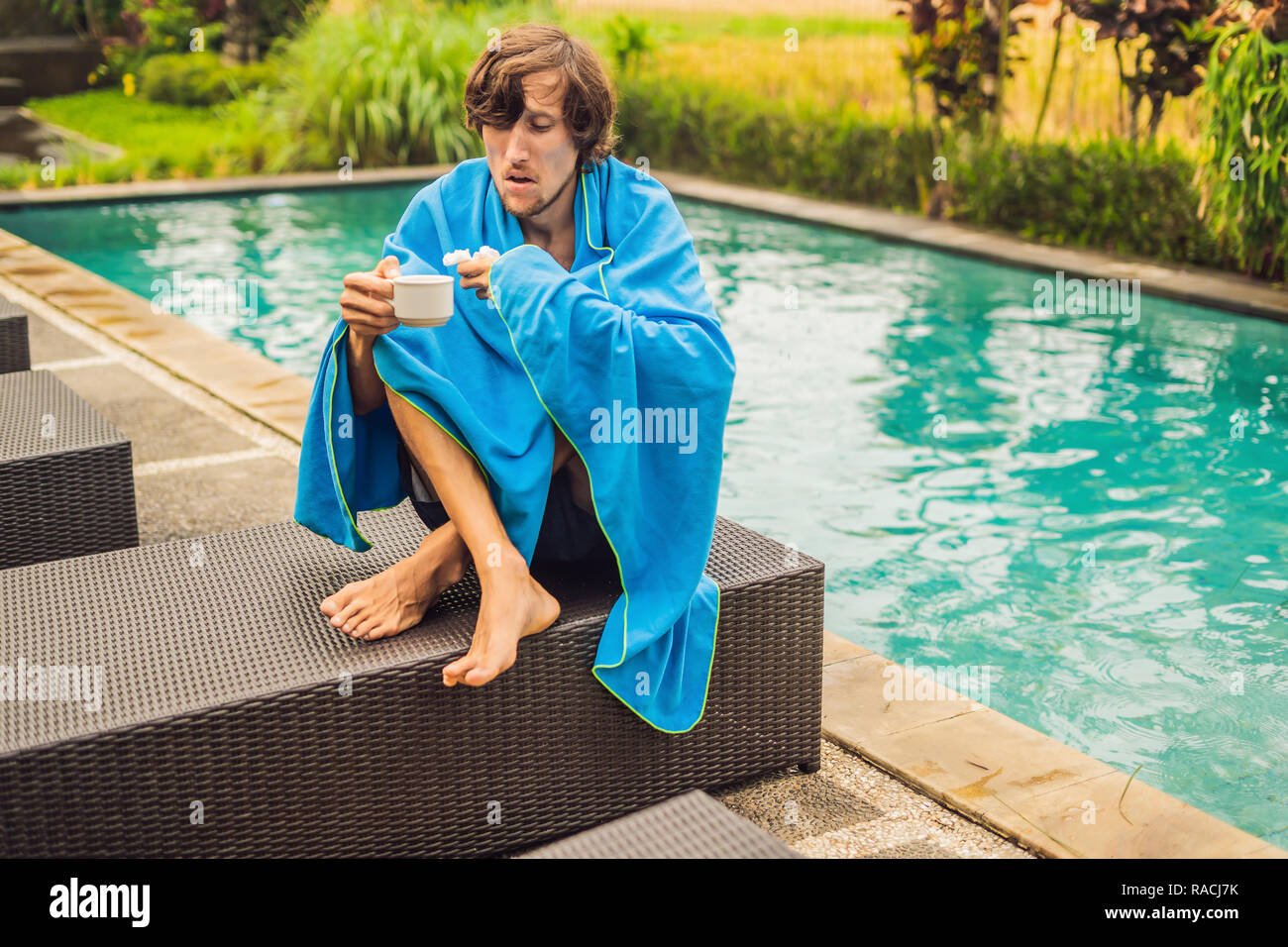 Sick man traveler. The man caught a cold on vacation, sits sad at the