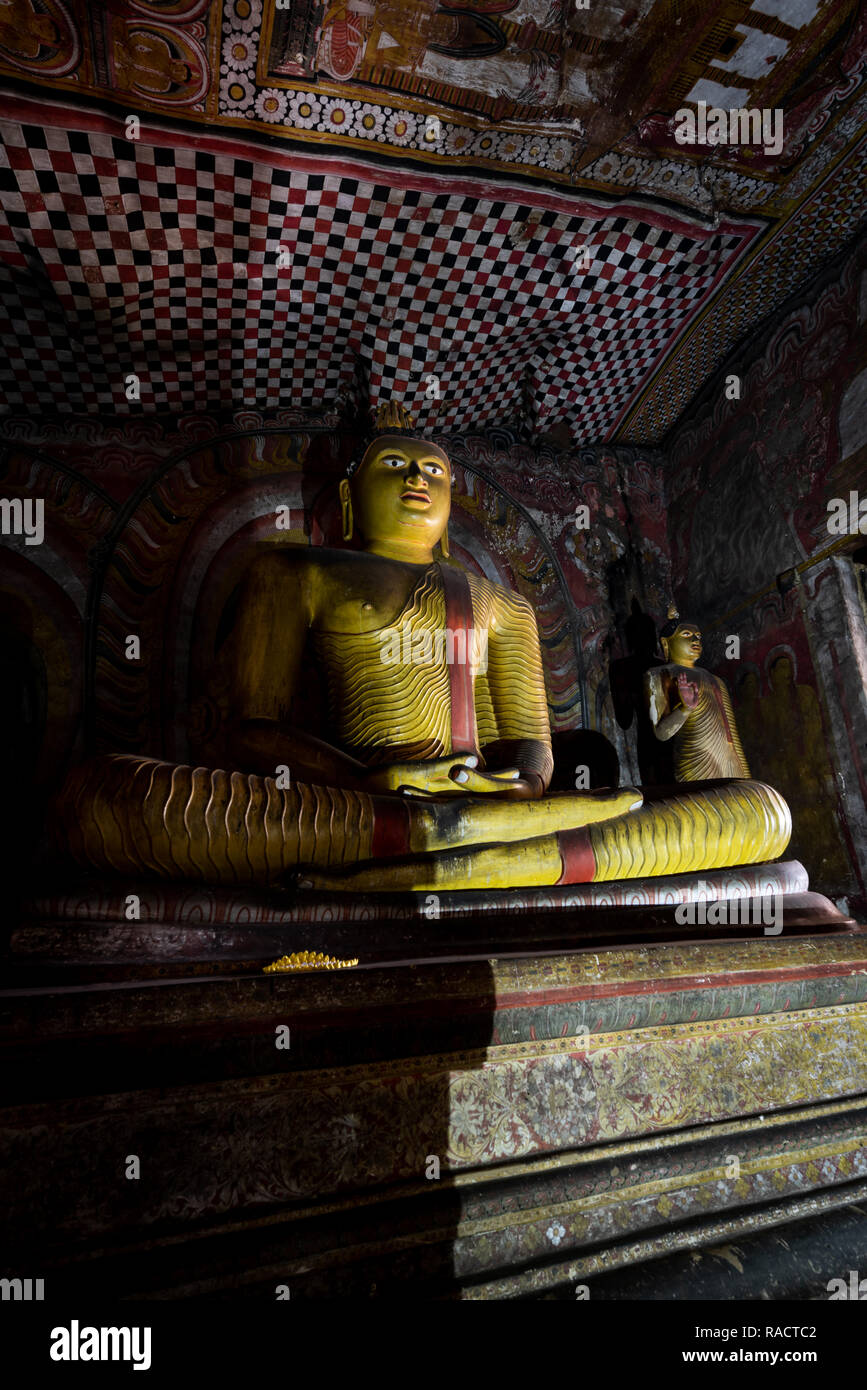 Buddha statues within the temple caves complex at Dambulla, Sri Lanka. Stock Photo
