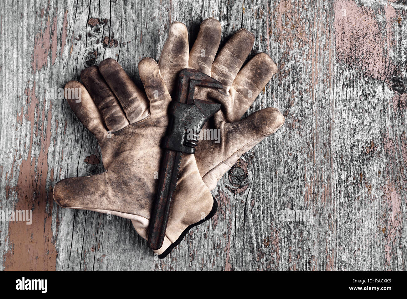 Old wrench on work glove Stock Photo