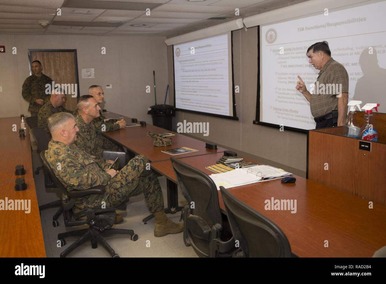 Mr. Lance Jeffrey, right, Training Support Center Lead, Training and Education Command, briefs Gen. Glenn Walters the Assistant Commandant of the Marine Corps and senior leaders on the usage of simulator training systems during a visit to Camp Lejeune, N.C., Jan. 26, 2017. The purpose of the visit was to increase awareness and capabilities of ground simulation and simulator training systems in support of operational forces combat readiness. Stock Photo