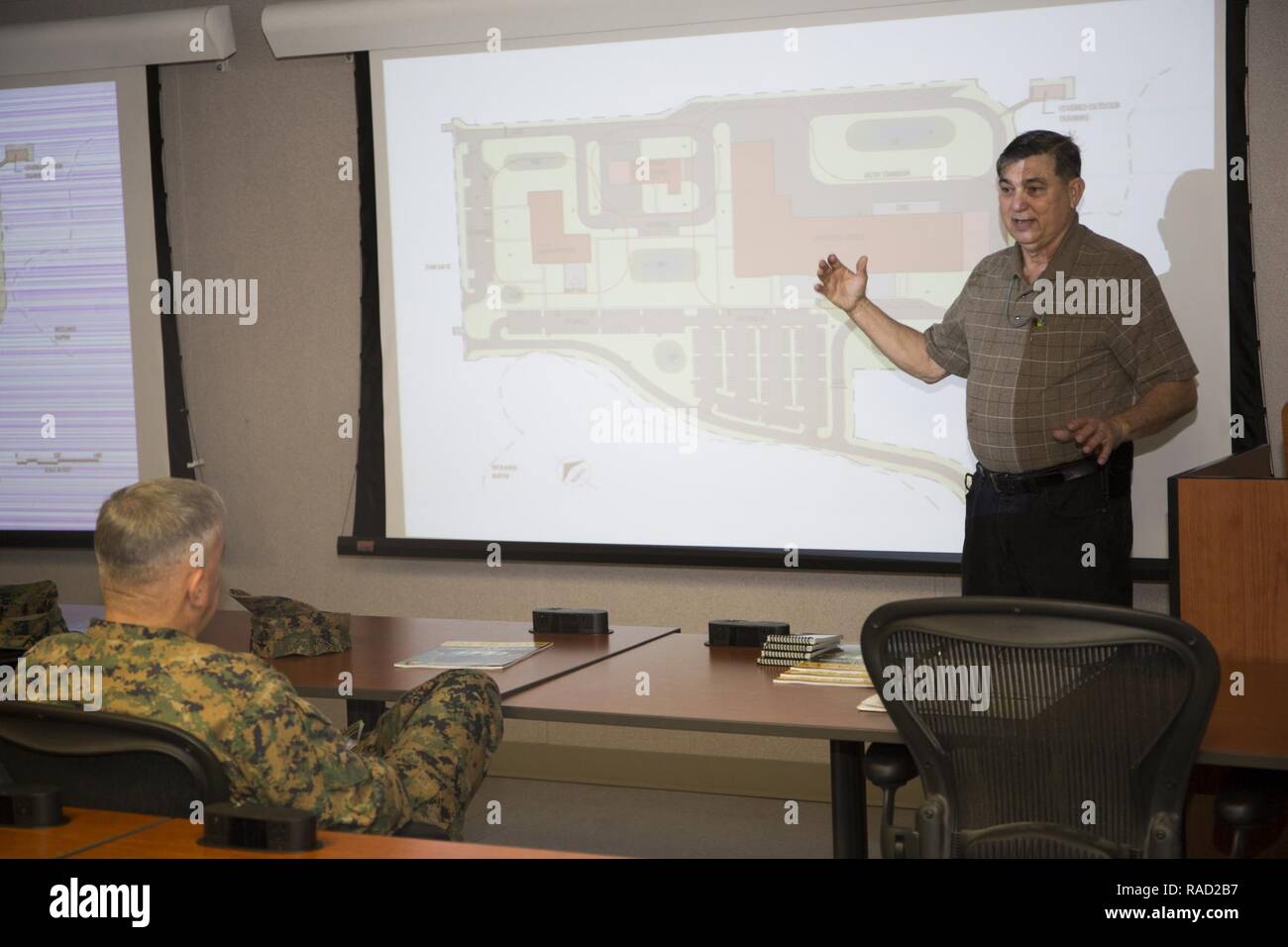 Mr. Lance Jeffrey, right, Training Support Center Lead, Training and Education Command, briefs Gen. Glenn Walters the Assistant Commandant of the Marine Corps and senior leaders on the usage of simulator training systems during a visit to Camp Lejeune, N.C., Jan. 26, 2017. The purpose of the visit was to increase awareness and capabilities of ground simulation and simulator training systems in support of operational forces combat readiness. Stock Photo