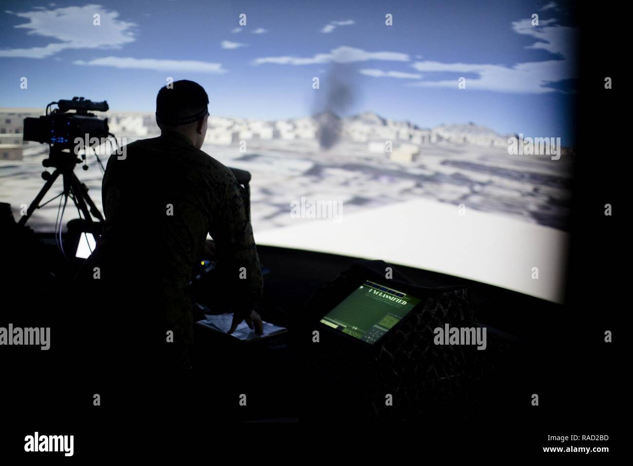 A U.S. Marine with 2nd Marine Division utilizes a Supporting Arms Virtual Trainer during a visit from Gen. Glenn Walters, Assistant Commandant of the Marine Corps, Camp Lejeune, N.C., Jan. 26, 2017. The purpose of the visit was to increase awareness and capabilities of ground simulation and simulator training systems in support of operational forces combat readiness. Stock Photo