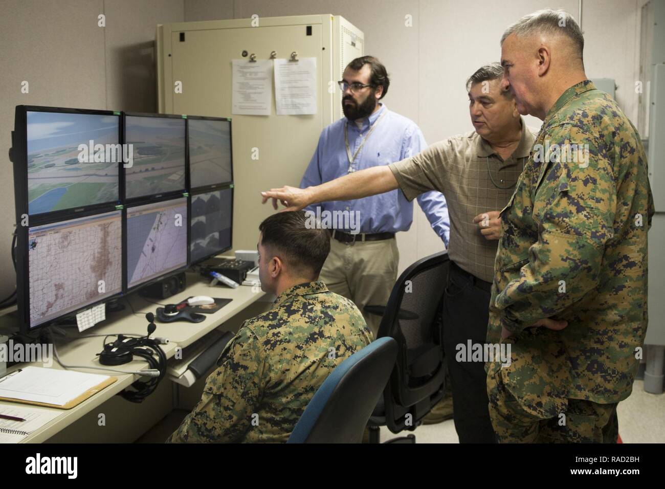 Mr. Lance Jeffrey, Training Support Center Lead, Training and Education Command, briefs Gen. Glenn Walters the Assistant Commandant of the Marine Corps on the usage of simulator training systems during a visit to Camp Lejeune, N.C., Jan. 26, 2017. The purpose of the visit was to increase awareness and capabilities of ground simulation and simulator training systems in support of operational forces combat readiness. Stock Photo
