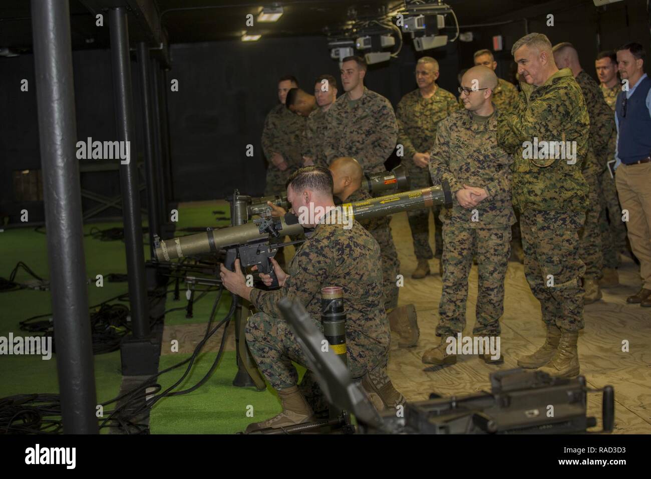 U.S. Marine Corps Gen. Glenn Walters, right, the Assistant Commandant of the Marine Corps observes Marines training on simulator training systems during a visit to Camp Lejeune, N.C., Jan. 27, 2017. The purpose of the visit was to increase awareness and capabilities of ground simulation and simulator training systems in support of operational forces combat readiness. Stock Photo