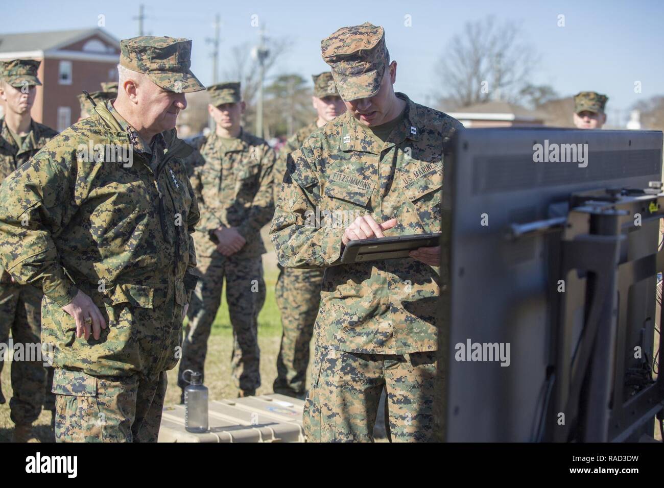 Mr. Lance Jeffrey, right, Training Support Center Lead, Training and Education Command, briefs Gen. Glenn Walters the Assistant Commandant of the Marine Corps and senior leaders on the usage of simulator training systems during a visit to Camp Lejeune, N.C., Jan. 27, 2017. The purpose of the visit was to increase awareness and capabilities of ground simulation and simulator training systems in support of operational forces combat readiness. Stock Photo