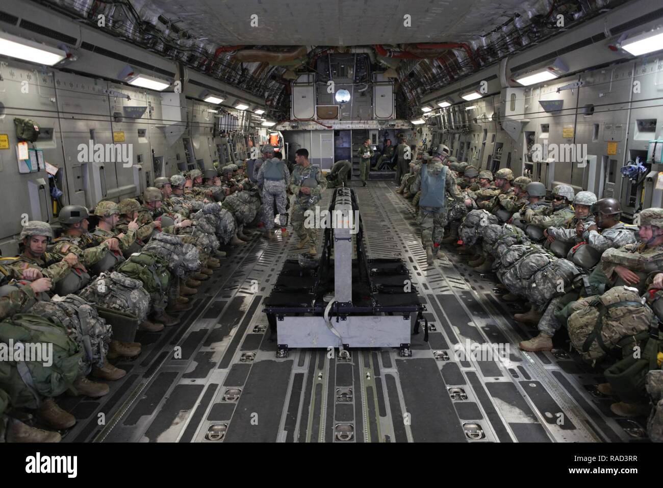 U.S. Army paratroopers assigned to the 360th Civil Affairs Brigade and other supporting units wait to jump from a U.S. Air Force C-17 Globemaster for a mass tactical Airborne jump for Operation Anvil in North Air Force Auxiliary Base, North, South Carolina, Jan. 26, 2017. The 360th Civil Affairs Brigade hosts Operation Anvil so jumpmasters can perform duties and jumpers can maintain currency for jump status. Stock Photo