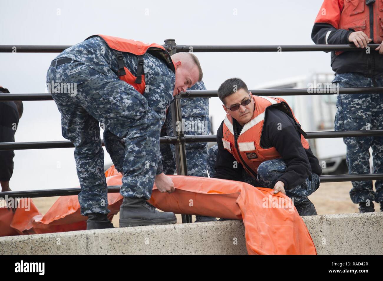 US Navy Engineman 2nd Class Anthony Bartelli (right) holds an