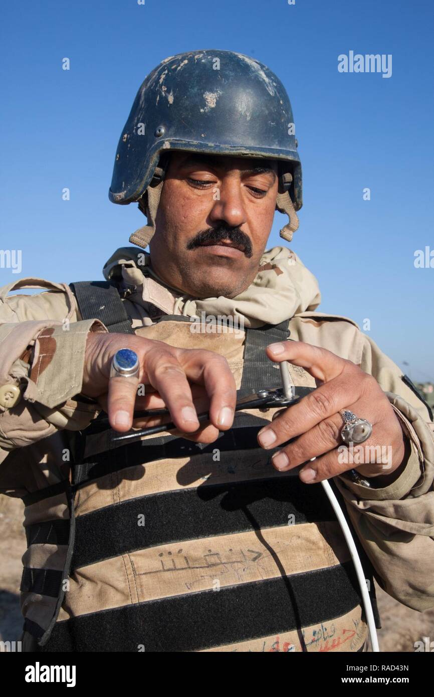 An Iraqi security force soldier prepares detonating cord as he constructs an explosive device