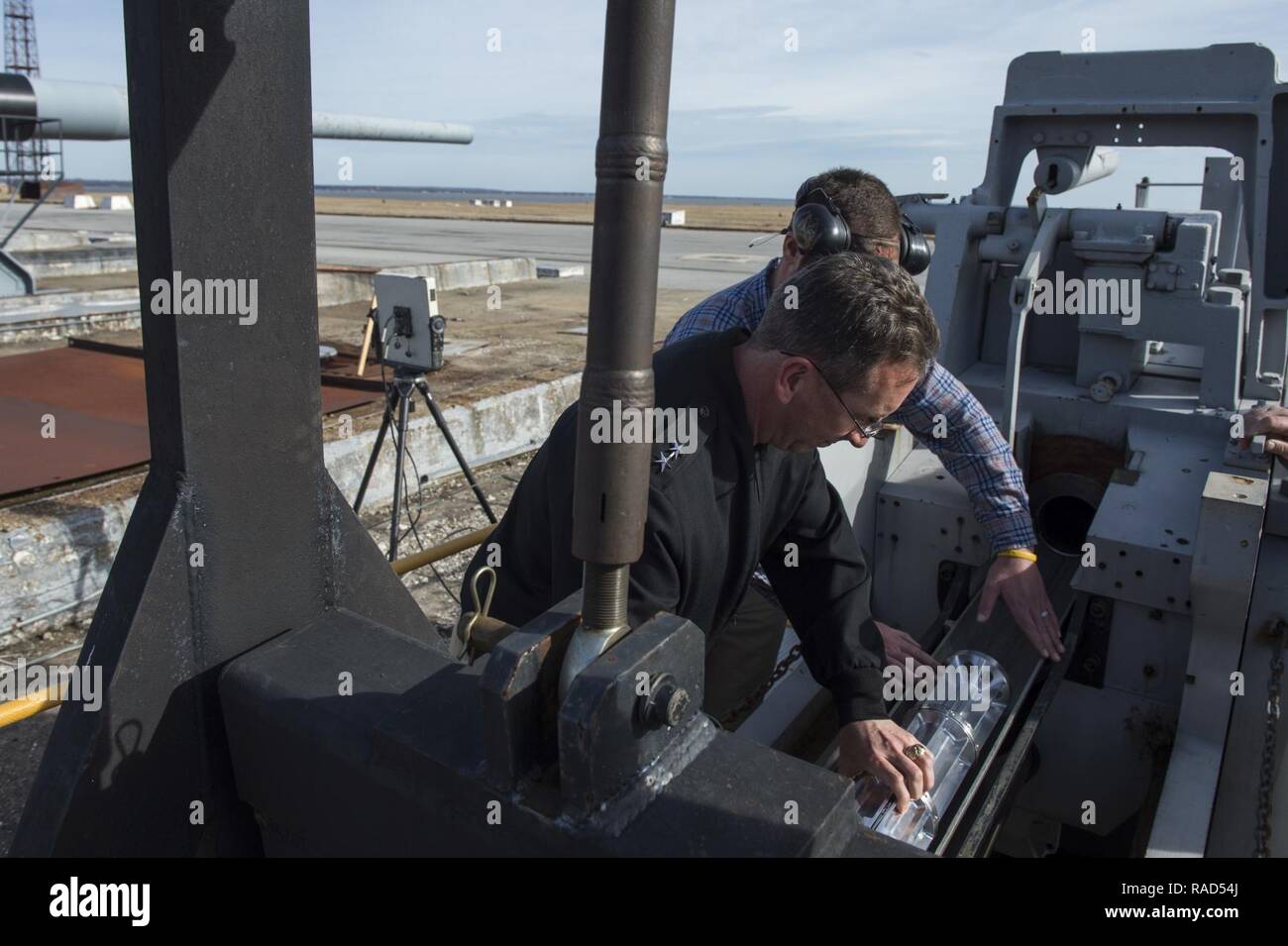 DAHLGREN (Jan. 12, 2017) Rear Adm. David Hahn, chief of naval research, assists with loading a Hyper Velocity Projectile (HVP) into a traditional powder gun during a visit to the Naval Surface Warfare Center, Dahlgren Division. The HVP is a next-generation, low drag, guided projectile capable of completing multiple missions for gun systems such as the Navy five-Inch guns and future railguns. Stock Photo