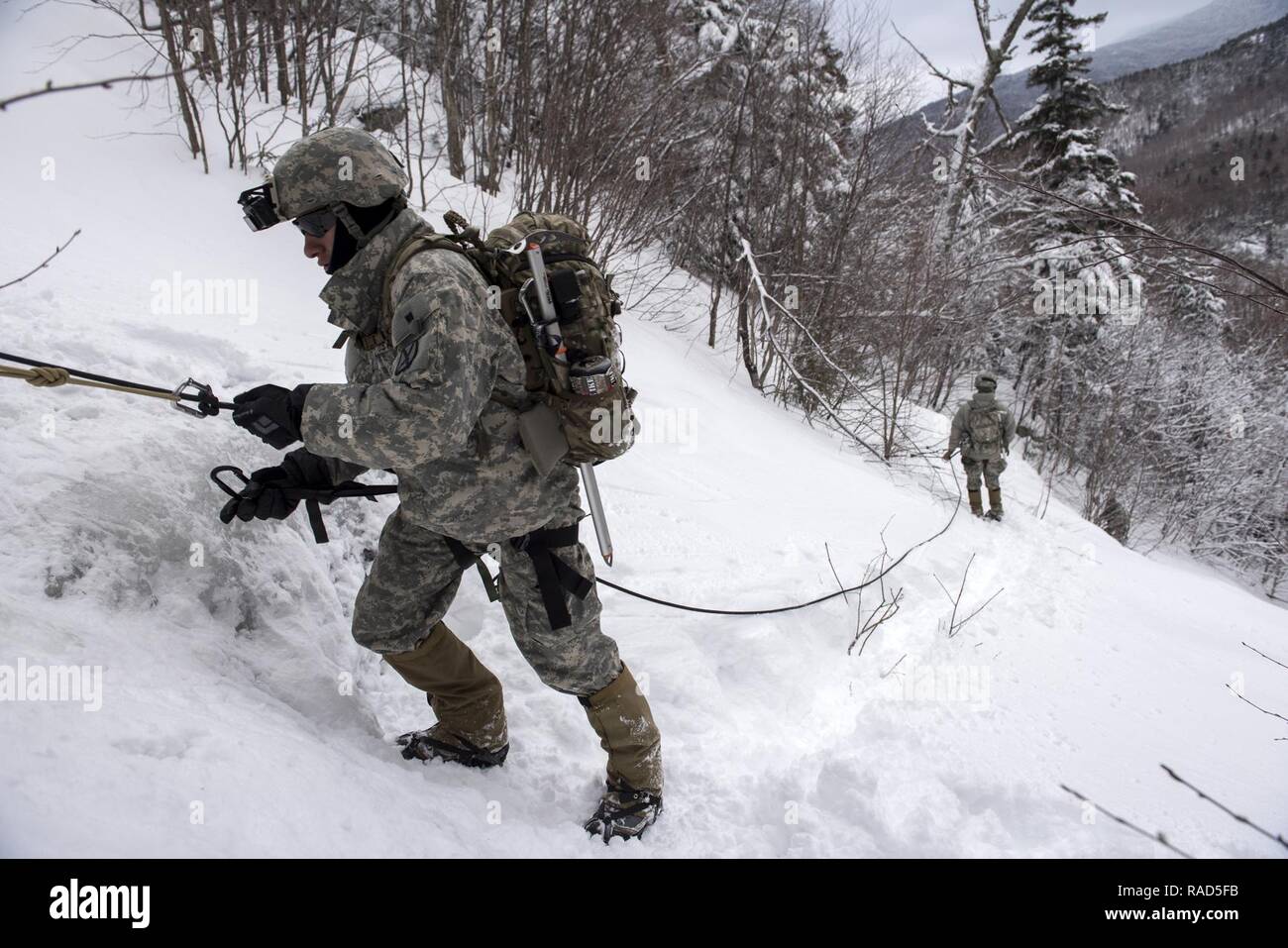 U.S. Army Spc. Saul Hernandez, infantryman, Alpha Company, 3rd Battalion, 172nd Infantry Regiment, 86th Infantry Brigade Combat Team (Mountain), Vermont National Guard participates in a mountain walk at Smugglers' Notch in Jeffersonville, Vt., Jan. 28, 2017. As part of their winter field training exercise, Soldiers enhanced their mountaineering skills in skiing, ice climbing and rappelling. Stock Photo