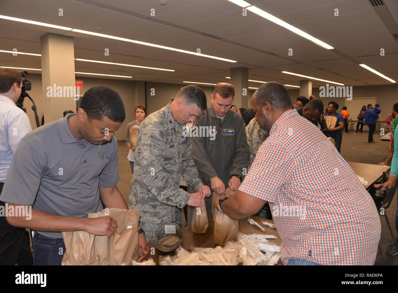 Columbus community members, including Col. Doug Gosney, 14th Flying Training Wing Commander, and Col. James Fisher, 14FTW Vice Wing Commander, pack bag lunches during the Dr. Martin Luther King Jr. Breakfast and Day of Giving event Jan. 16, 2017, in Columbus, Mississippi.  Members from Columbus Air Force Base, the City of Columbus, the Columbus-Lowndes Convention and Visitors Bureau, Lowndes County Board of Supervisors, Mississippi University for Women, Sodexo Food Services, and the United Way of Lowndes County all participated in the event to show their support. Stock Photo