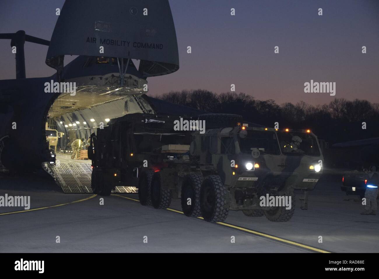 A heavy expanded mobility tactical truck pulls a radar system from the ...