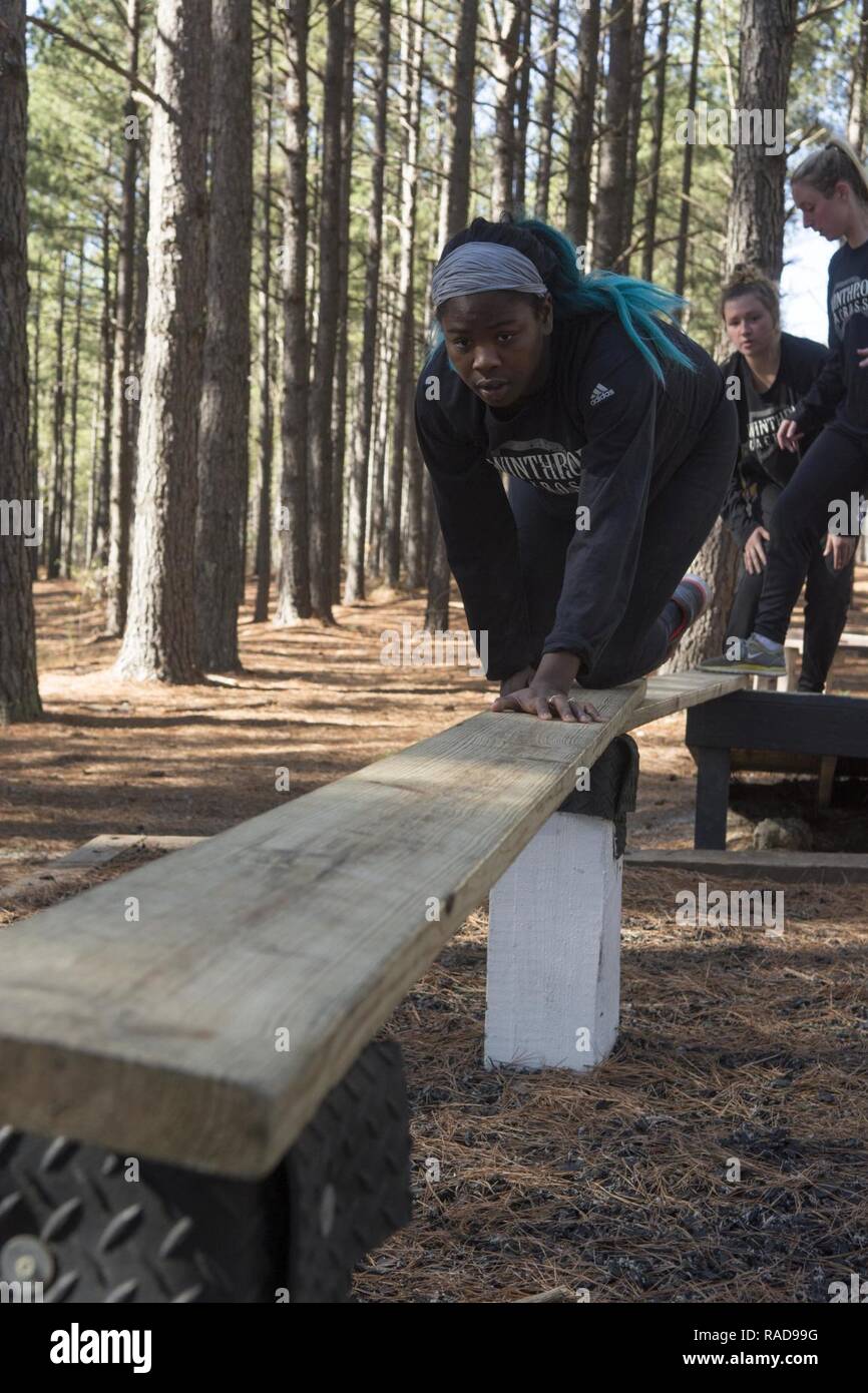 Karen Grant, a junior defenderwith the Winthrop University Womens Lacrosse  Team, steadies a board as she builds a bridge during a visit to Fort  Jackson Jan. 28. Grant, a native of Charleston, S.C.., and her team spent  the day at Fort Jackson facing mental ...