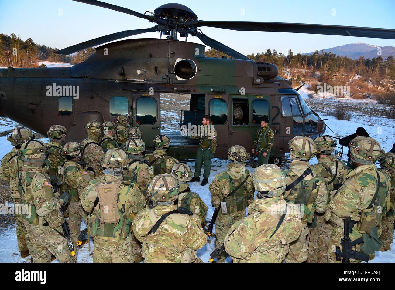 U.S. Army paratroopers from the 173rd Brigade Support Battalion, 173rd Airborne Brigade, receive a brief from Slovenian soldiers before casualty evacuation training with Slovenian Air Force Eurocopter H3-72 during exercise Lipizzaner III in Pocek, Slovenia, Jan. 28, 2017. Lipizzaner is a combined squad-level training exercise in preparation for platoon evaluation, and to validate battalion-level deployment procedures. Stock Photo