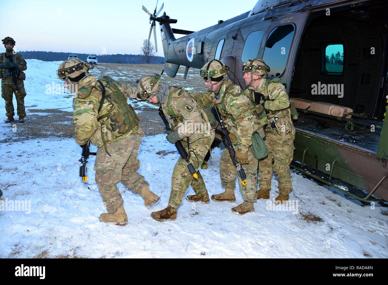 U.S. Army paratroopers from the 173rd Brigade Support Battalion, 173rd Airborne Brigade, return  following a simulated casualty carry aboard a Slovenian Air Force Eurocopter H3-72, during a casualty evacuation training during exercise Lipizzaner III in Pocek, Slovenia, Jan. 28, 2017. Lipizzaner is a combined squad-level training exercise in preparation for platoon evaluation, and to validate battalion-level deployment procedures. Stock Photo