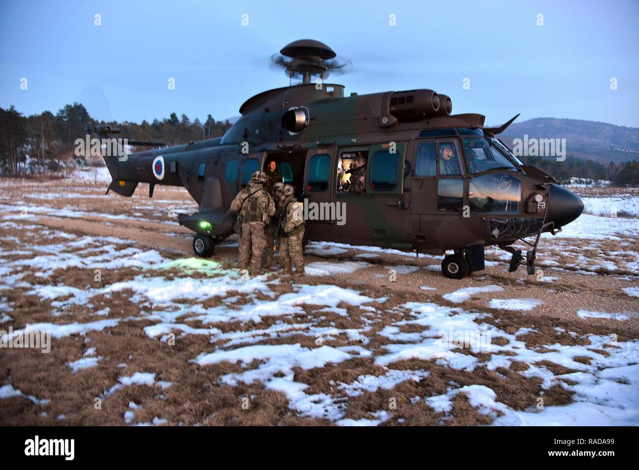 U.S. Army paratroopers from the 173rd Brigade Support Battalion, 173rd Airborne Brigade, conduct  a simulated casualty carry aboard a Slovenian Air Force Eurocopter H3-72, during a casualty evacuation training during exercise Lipizzaner III in Pocek, Slovenia, Jan. 28, 2017. Lipizzaner is a combined squad-level training exercise in preparation for platoon evaluation, and to validate battalion-level deployment procedures. Stock Photo