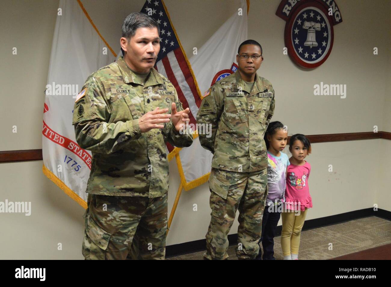 Lt. Col. David Clukey (left), commander, Phoenix Recruiting Battalion, praises Master Sgt. Redus Thomas, operations noncommissioned officer in charge, Phoenix Rec. Bn., during a promotion ceremony for Thomas, Feb. 1, battalion headquarters, Phoenix. Thomas was joined for the ceremony by his daughters Kaylah (left) and Lilyona (right). Stock Photo