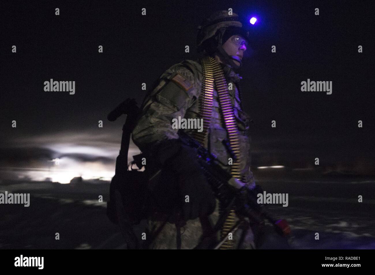 Army Pfc. Richard Burger, assigned to the 574th Composite Supply Company, 17th Combat Sustainment Support Battalion, U.S. Army Alaska, proceeds to a rally point after conducting force-protection sustainment training at Joint Base Elmendorf-Richardson, Alaska, Feb. 1, 2017. Paratroopers from the 1st Battalion, 501st Parachute Infantry Regiment, 4th Infantry Brigade Combat Team (Airborne), 25th Infantry Division, provided guidance and also acted as opposition forces during the exercise. The logistics Soldiers, from Fort Wainwright and JBER, participated in a week-long combat skills training exer Stock Photo