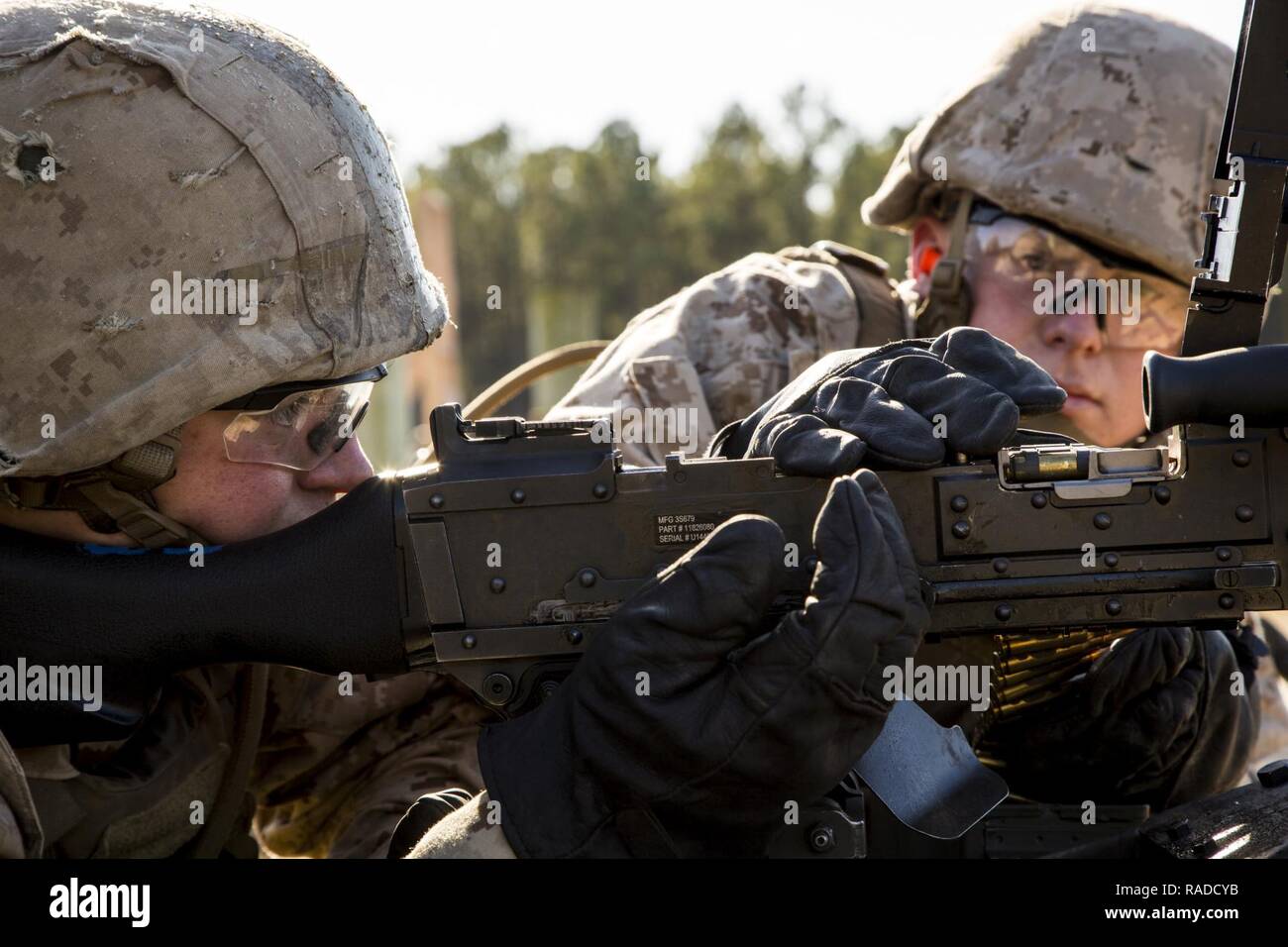 Entry level Marines with Kilo Company, Marine Combat Training Battalion (MCT), School of Infantry-East, reload a M240G Medium Machinegun during a live fire exercise on Camp Lejeune, N.C., Jan. 13, 2017. Marines attending MCT conducted a live fire exercise to familiarize themselves with the weapon system. Stock Photo