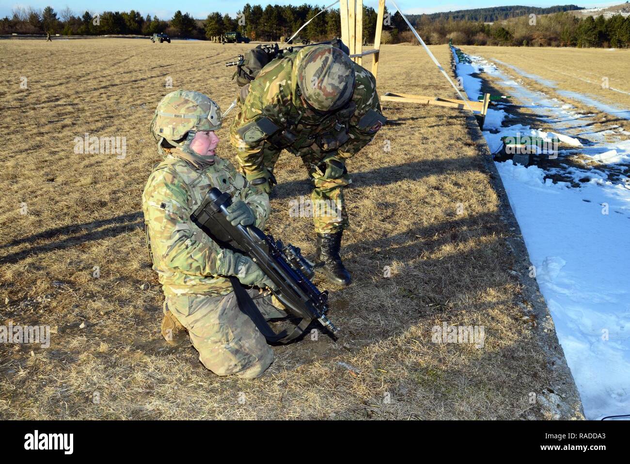 U.S. Army paratroopers from the 173rd Brigade Support Battalion, 173rd Airborne Brigade and Slovenian soldiers cross-train on the M4 carbine rifles and FN F2000 assault rifles during exercise Lipizzaner III in Bac, Slovenia, on Jan. 26, 2017. Lipizzaner is a combined squad-level training exercise in preparation for platoon evaluation, and to validate battalion-level deployment procedures. Stock Photo
