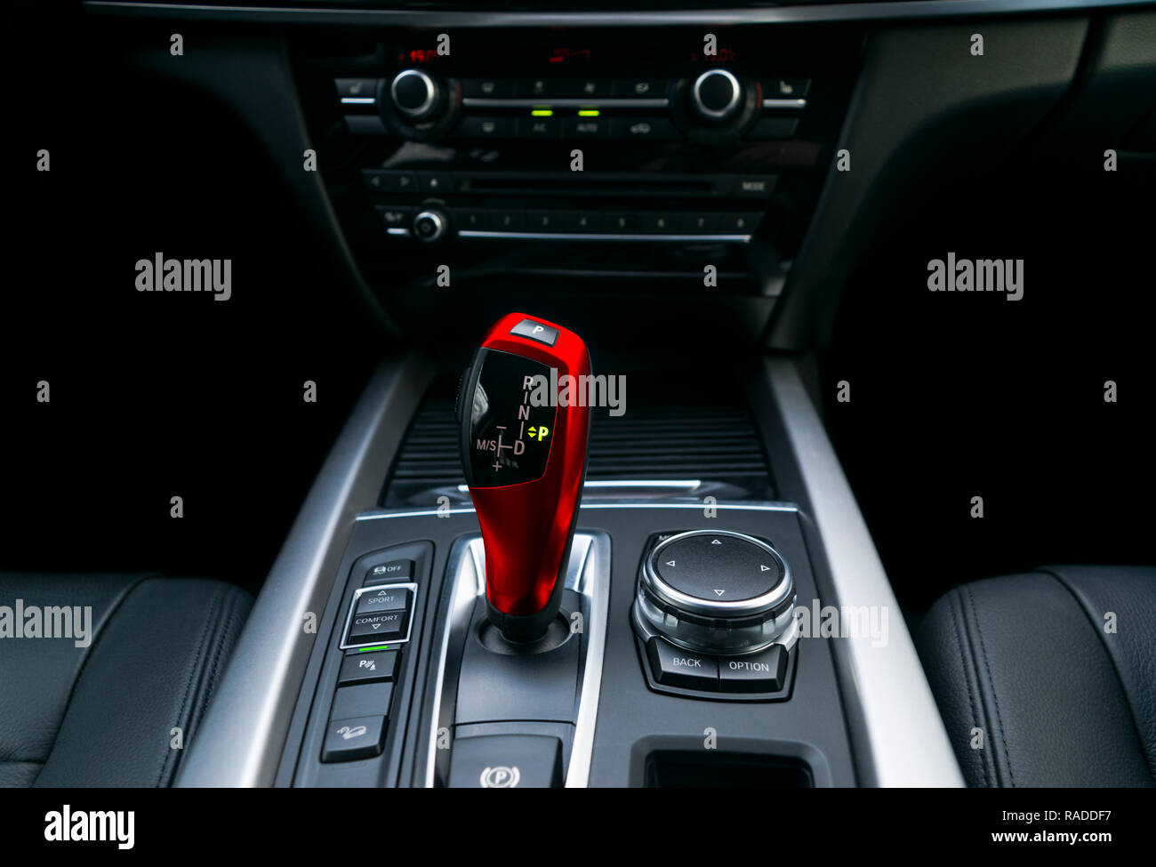 Red Automatic gear stick (transmission) of a modern car, multimedia and