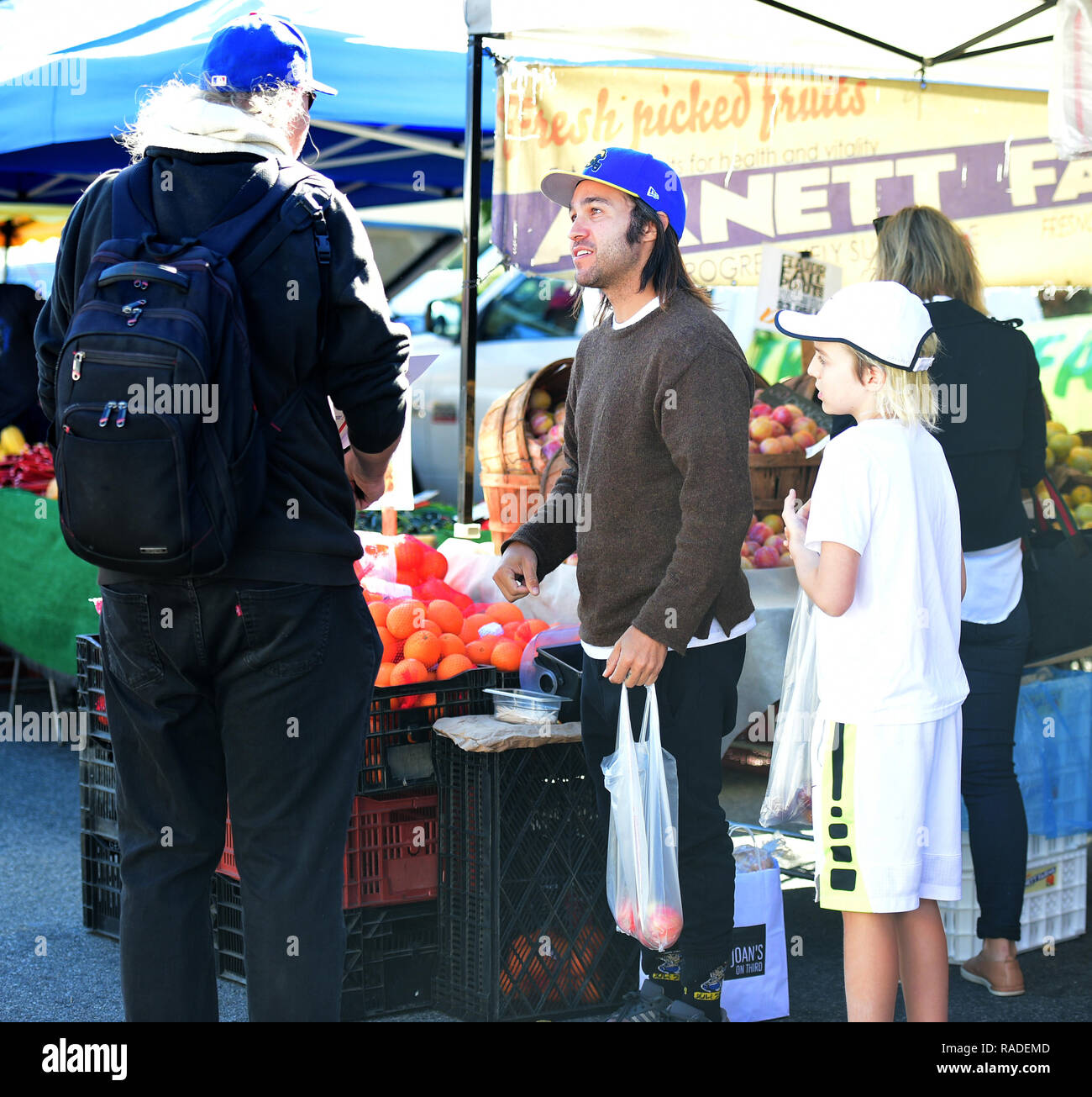 Pete Wentz signs an autograph for a fan while his son Bronx Wentz looks