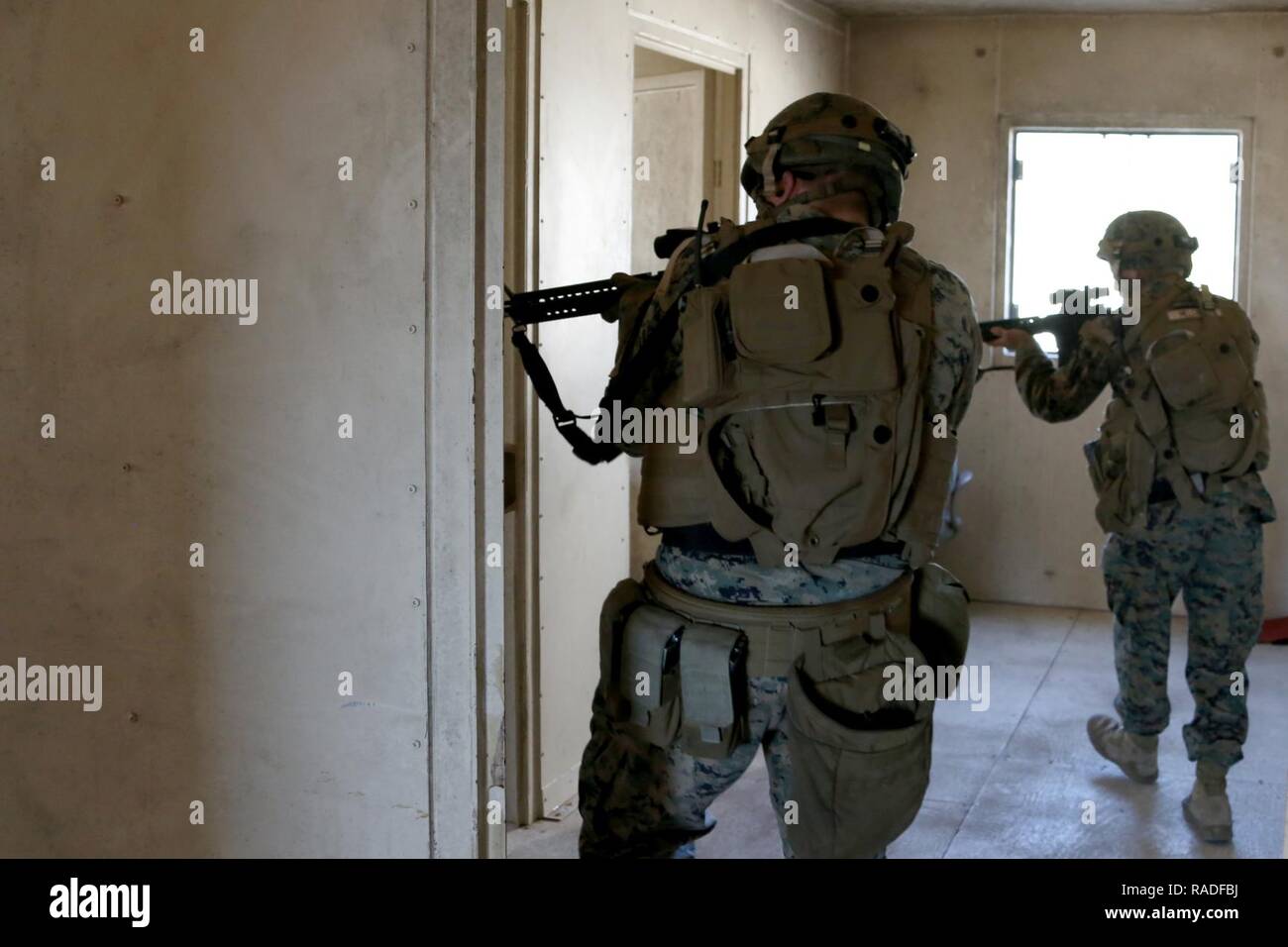 Marines clear a building during Military Operations in Urban Terrain training aboard Marine Corps Outlying Field Atlantic, N.C., Feb. 2, 2017. Nearly 40 Marines with supporting personnel participated in the weeklong training that simulated hostile takeovers and how to overcome unexpected situations with small unit leadership. “My end goal is to ensure any of my Marines are able to take my place if the situation arises,” said Cpl. Christian Leishman, a squad leader for the exercise. The Marines are assigned to Marine Wing Support Squadron 271, Marine Aircraft Group 14, 2nd Marine Aircraft Wing. Stock Photo