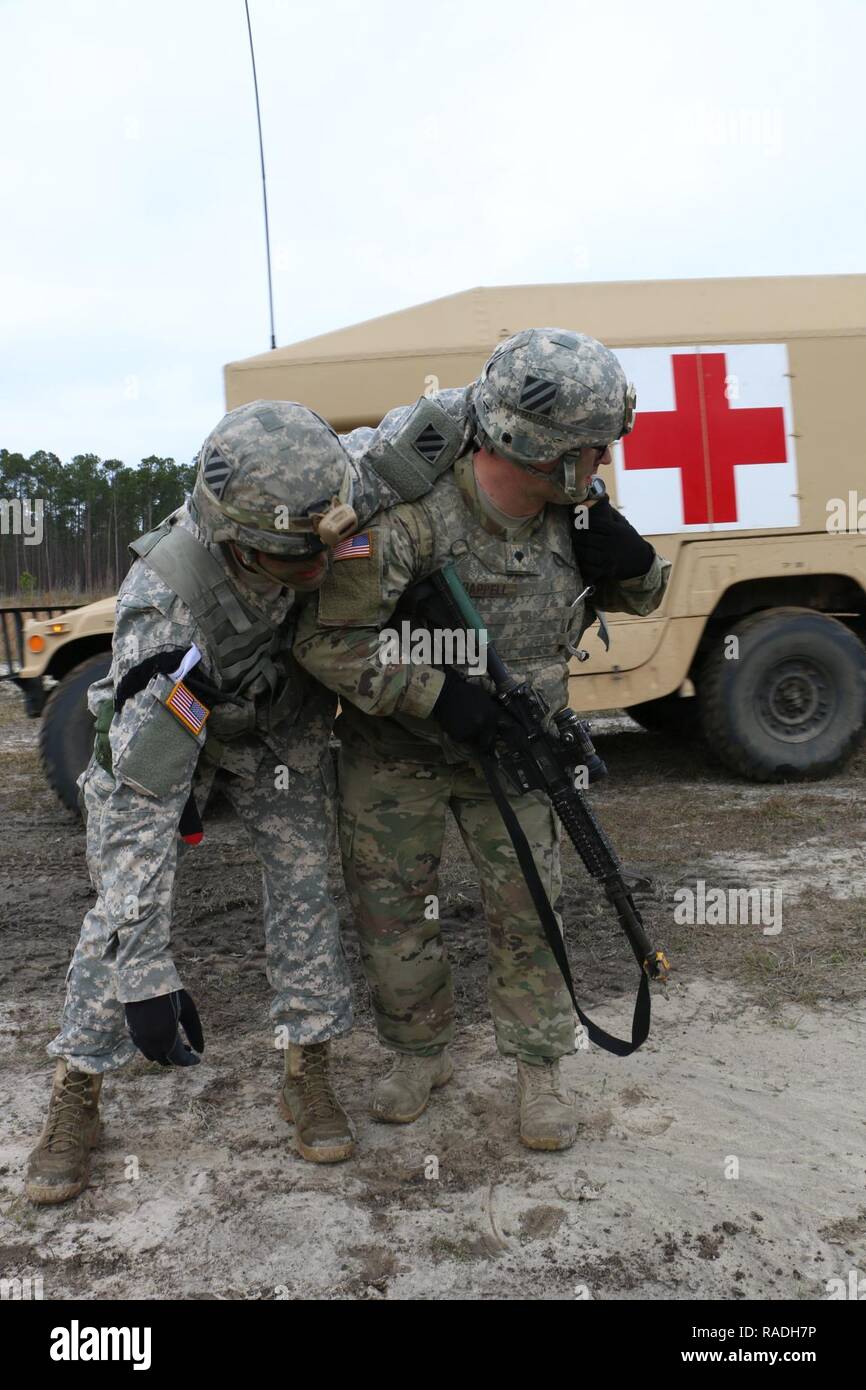 Spc. Blake Chappell, generator mechanic with Bravo Company, 703rd Brigade Support Battalion, 2nd Infantry Brigade Combat Team, 3rd Infantry Division, carries a notionally injured Soldier during medical training, January 26, 2017 at Fort Stewart, Ga. The battalion supported 3rd Battalion, 7th Infantry Regiment, 2nd IBCT, with on-call recovery, medical evacuation, and logistical distribution during training exercise Baler Focus, January 25 -27. Stock Photo
