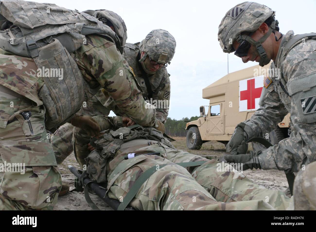 Soldiers of Bravo Company, 703rd Brigade Support Battalion, 2nd Infantry Brigade Combat Team, 3rd Infantry Division, strap a Soldier to a litter during medical training, January 26, 2017 at Fort Stewart, Ga. The battalion supported 3rd Battalion, 7th Infantry Regiment, 2nd IBCT, with on-call recovery, medical evacuation, and logistical distribution during training exercise Baler Focus, January 25 - 27. Stock Photo
