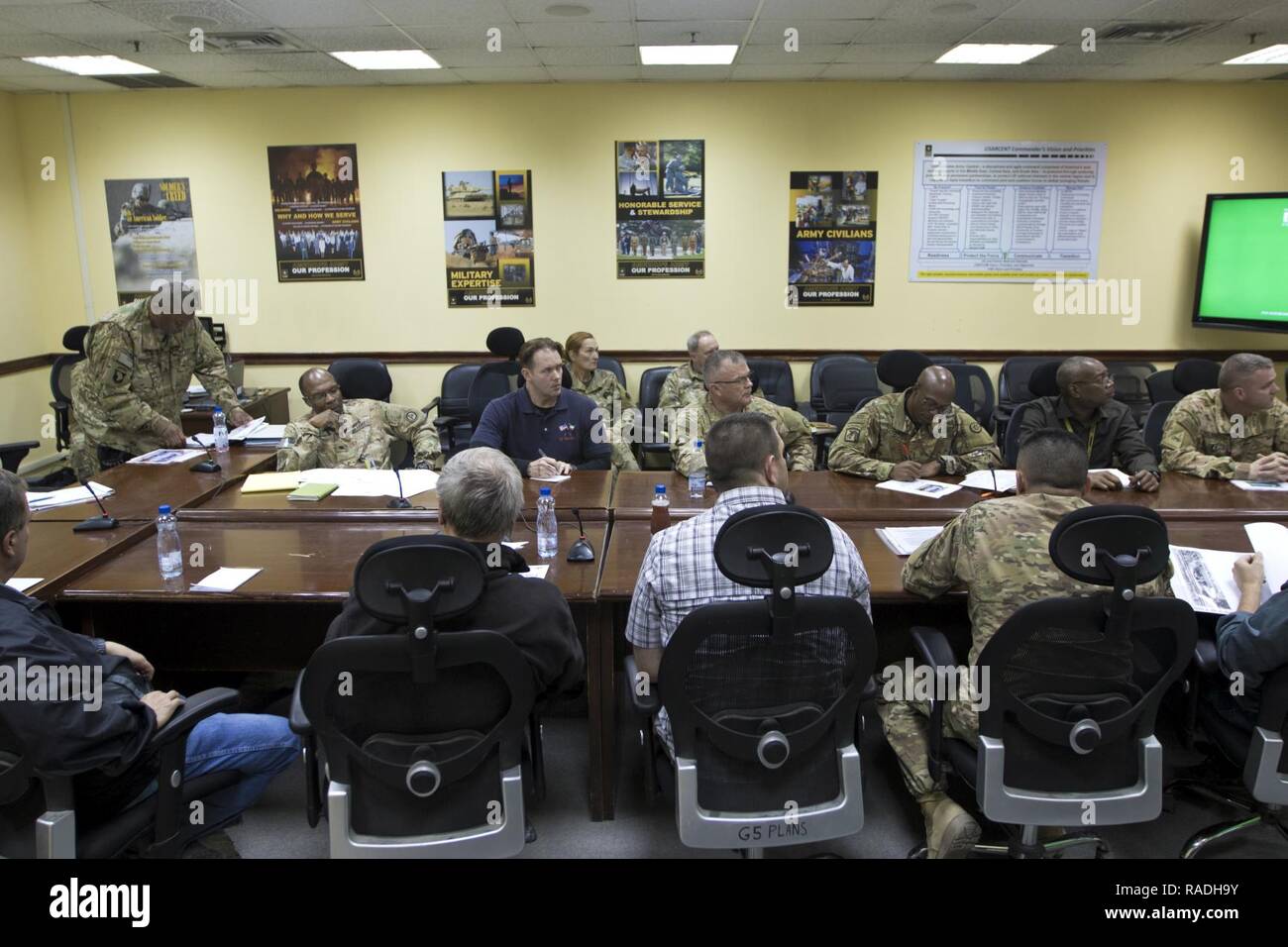 Rick Gravely, the 1st Sustainment Command (Theater) deputy safety director, (left), talks about the 2017 Worldwide Ammunition Logistics and Explosives Safety Review timeline in Camp Arifjan, Kuwait, on Jan. 20, 2017. The review, conducted by the U.S. Army Defense Ammunition Center, will carry out evaluations against a recognized standard, provide solutions to resolve issues or problems, teach and enhance knowledge base and to emphasize the fact that the reviews are not punitive in nature. Stock Photo