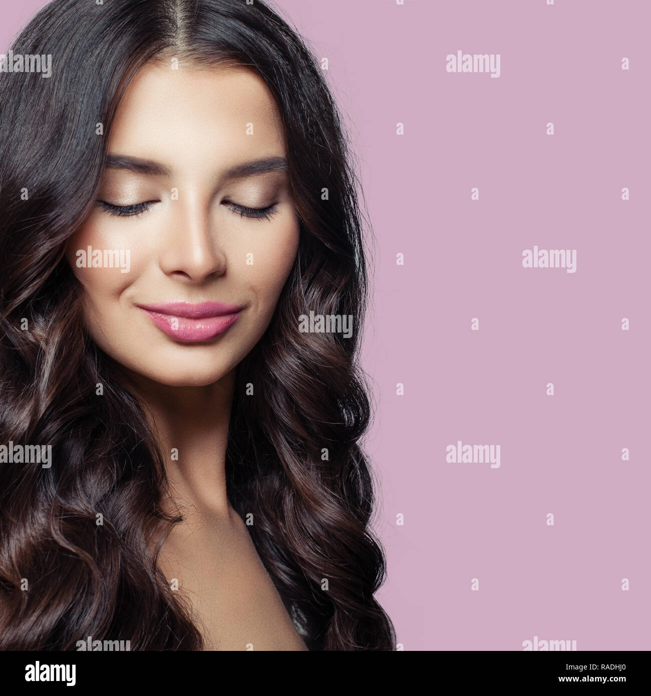 Beauty brunette girl. Young woman with long healthy hair and pink lips makeup on colorful background Stock Photo
