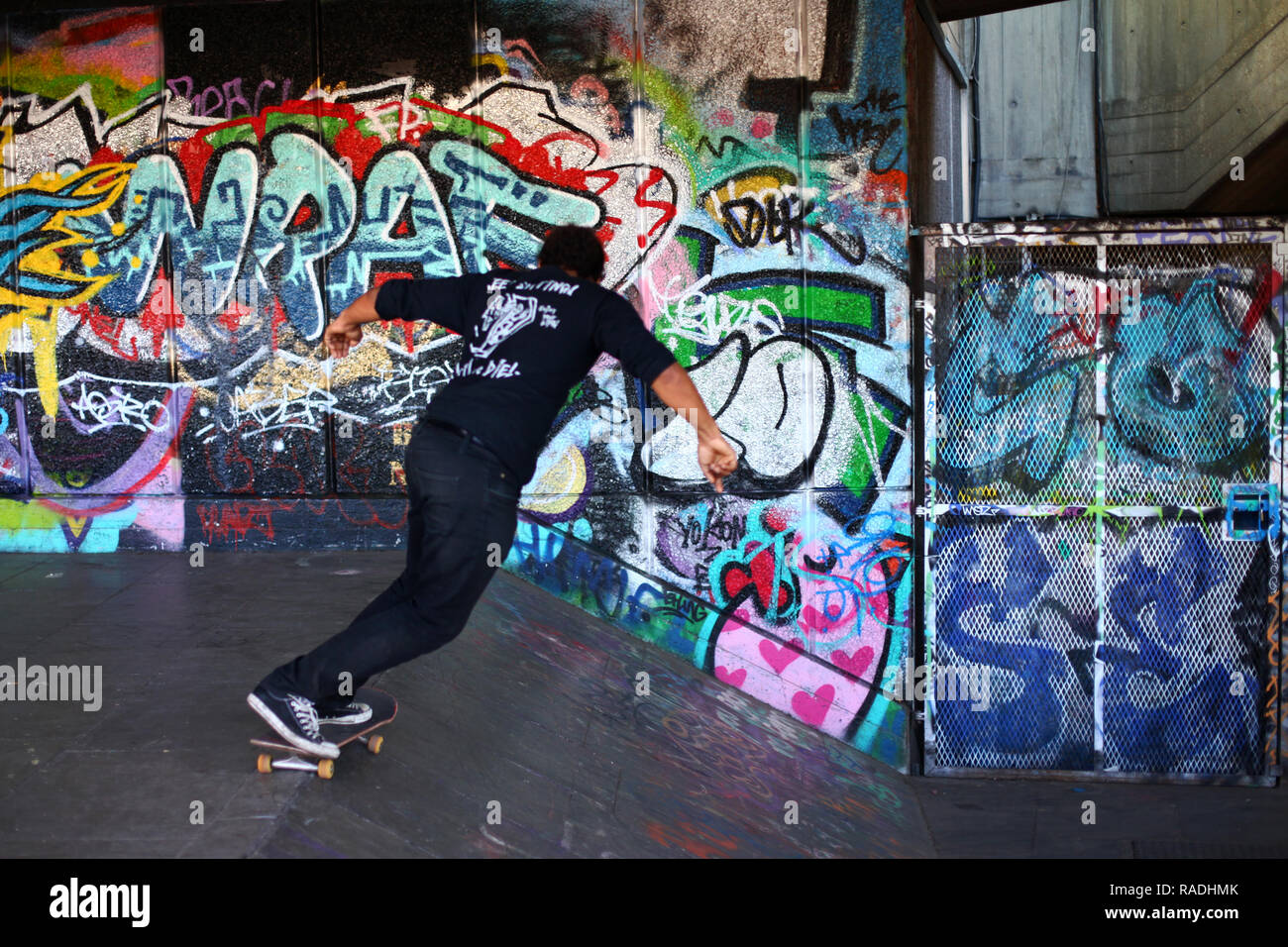 Skateboarding at the Undercroft Southbank London with grafitti background Stock Photo