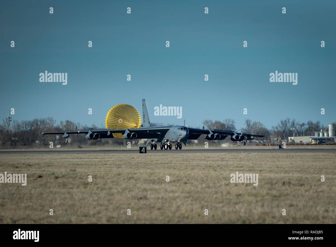 A B-52 Stratofortress deploys a drag chute during landing at Barksdale Air Force Base, La., Jan. 24, 2017. The drag parachute is used to decelerate the B-52 Stratofortress during landing, reducing wear and tear to ceramic pads used by the aircraft, increasing its life span. Stock Photo