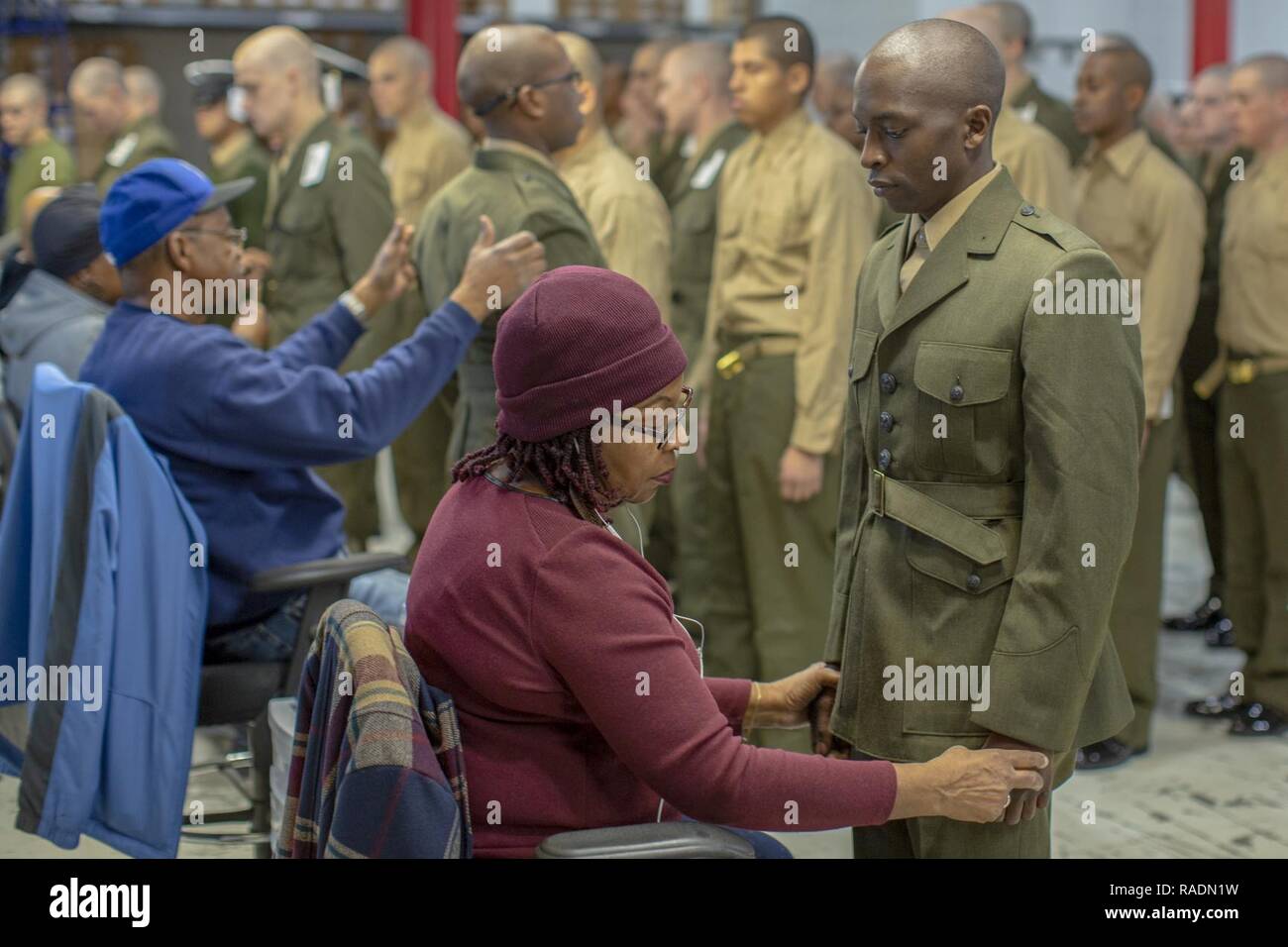 Fitter Jackie Scott checks the uniform of Recruit Mulunda Bwerevu to