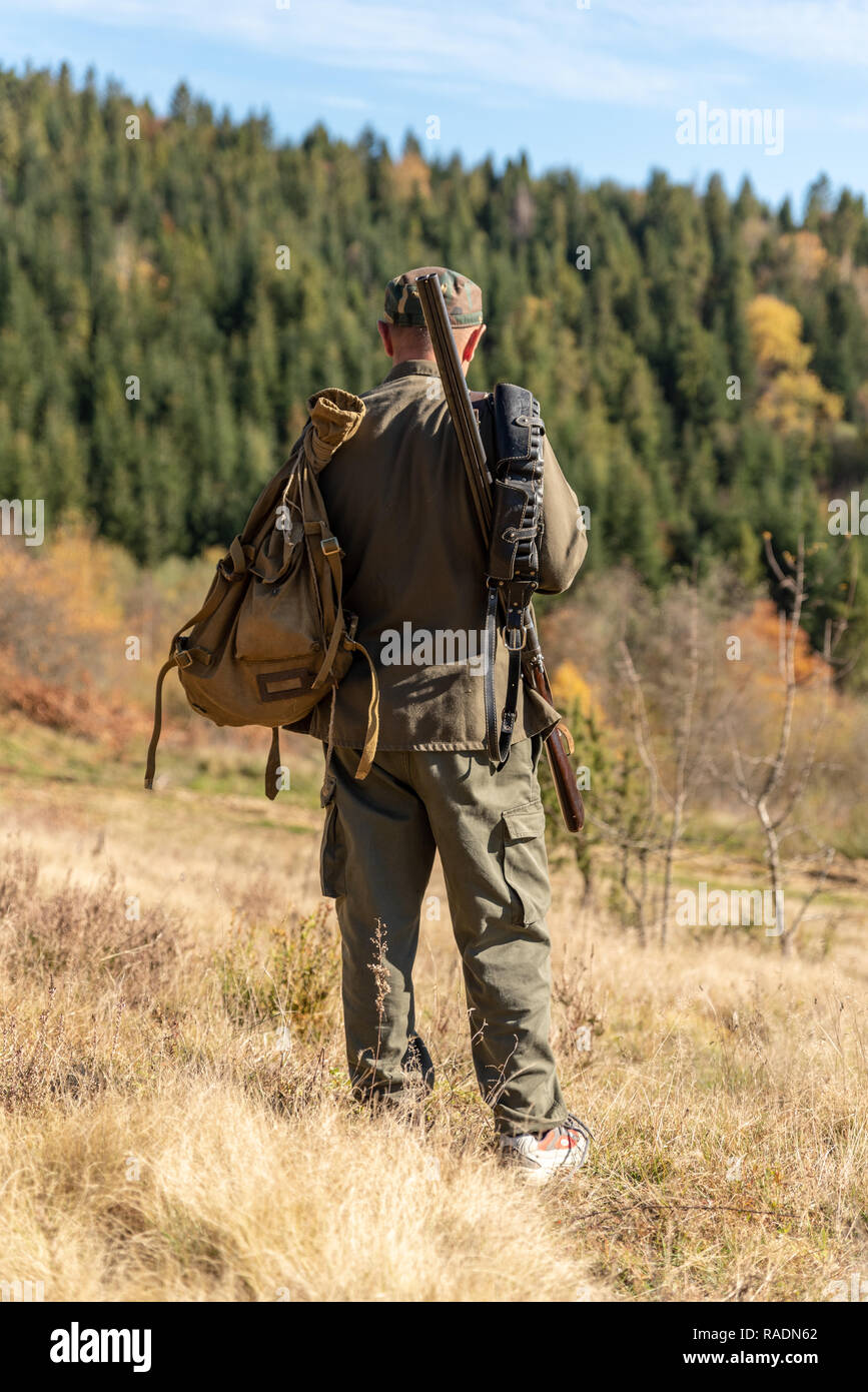Hunter on hunting in the mountains, forestland Stock Photo