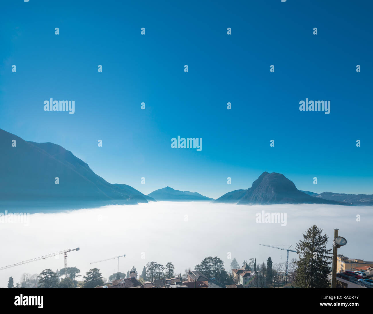Thermal inversion on the Lugano Lake in Switzerland Stock Photo