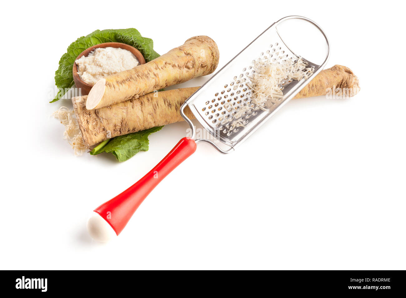 Fresh Horseradish Roots and sauce with shredder isolated on white background from above Stock