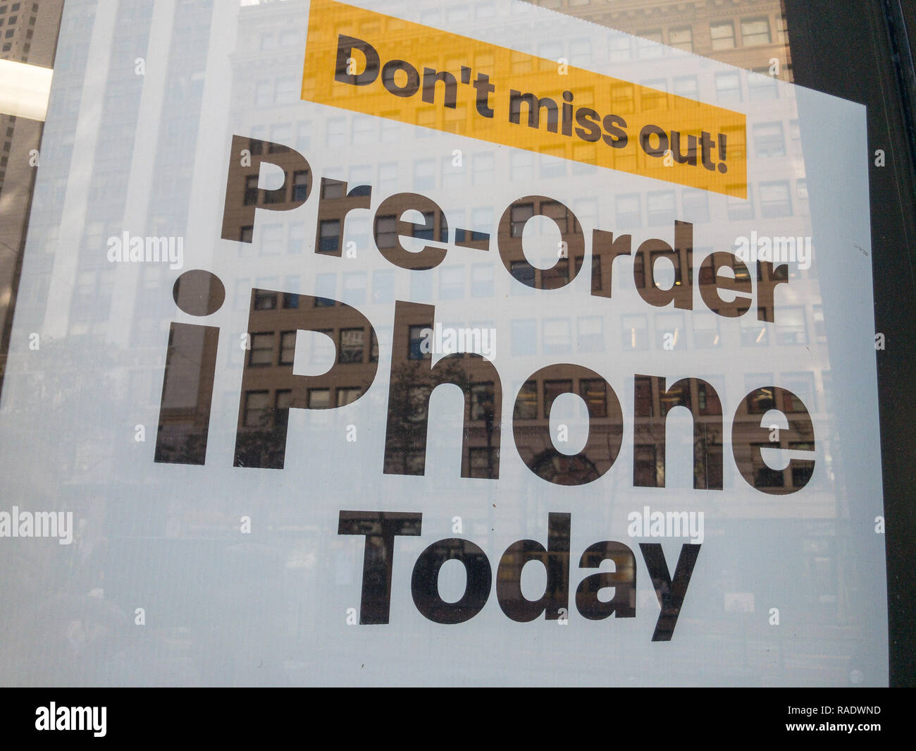 Pre-order Iphone today baner at the electronics shop window Stock Photo