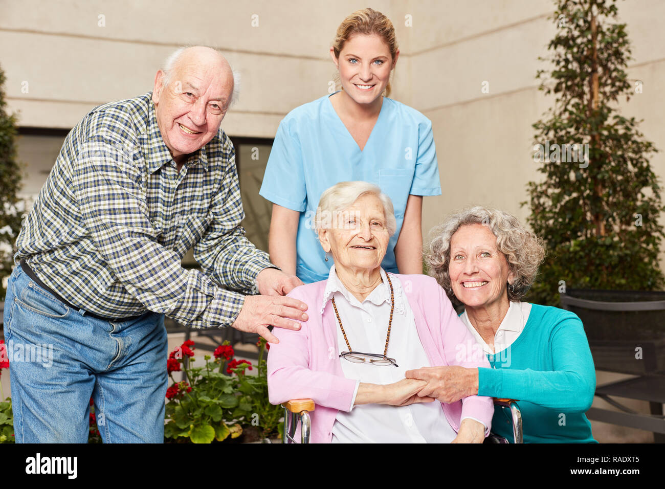 Group of seniors with geriatric nurse in nursing home or nursing home Stock Photo